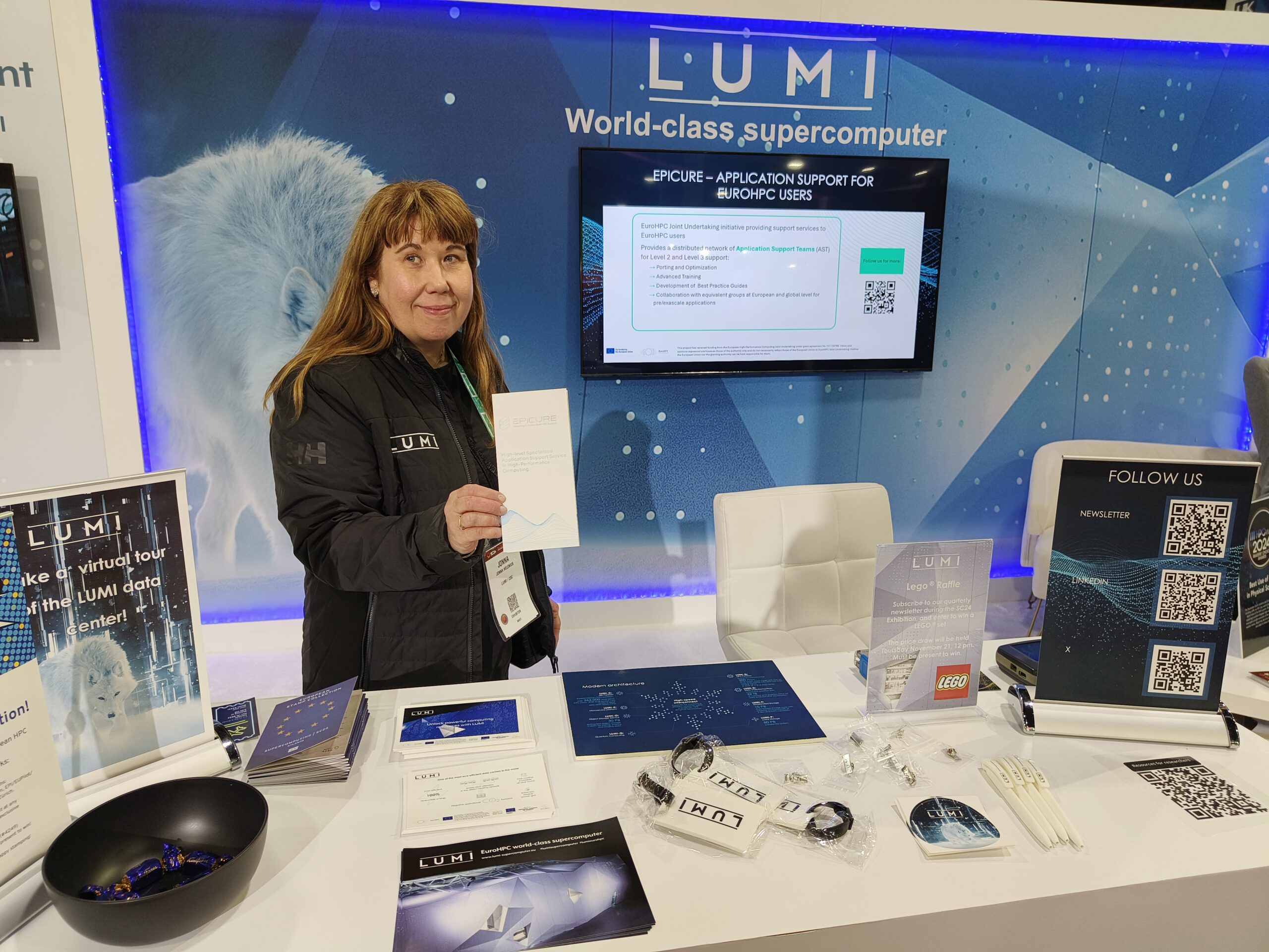 Photo of LUMI booth with EPICURE presentation.