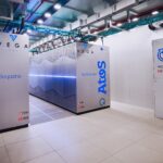 VEGA supercomputer and Atos BullSequana cabinets in a bright data centre environment.
