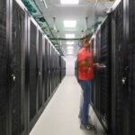 Male person with red t-shirt working in the Deucalion supercomputer