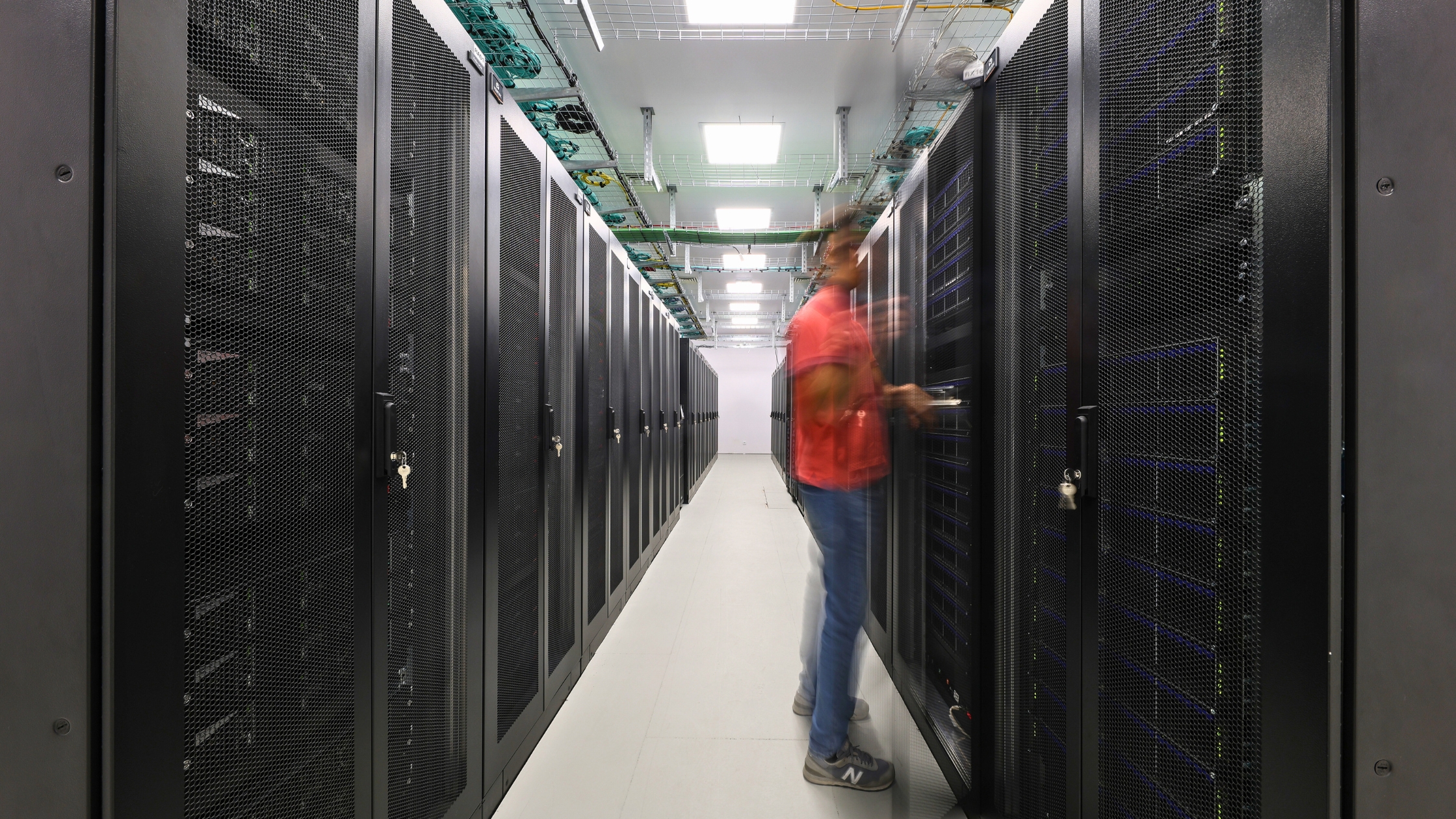 Male person with red t-shirt working in the Deucalion supercomputer