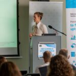 Woman speaker presenting HPC support initiatives at SLING Days 2025.