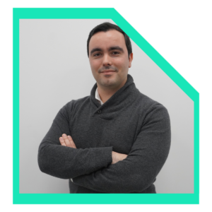 Men wearing a grey sweater with arms-crossed.