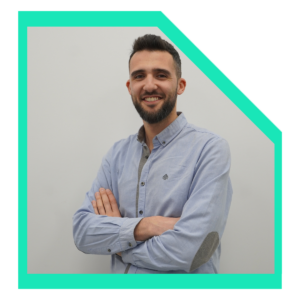 Men wearing a light blue shirt with arms crossed.