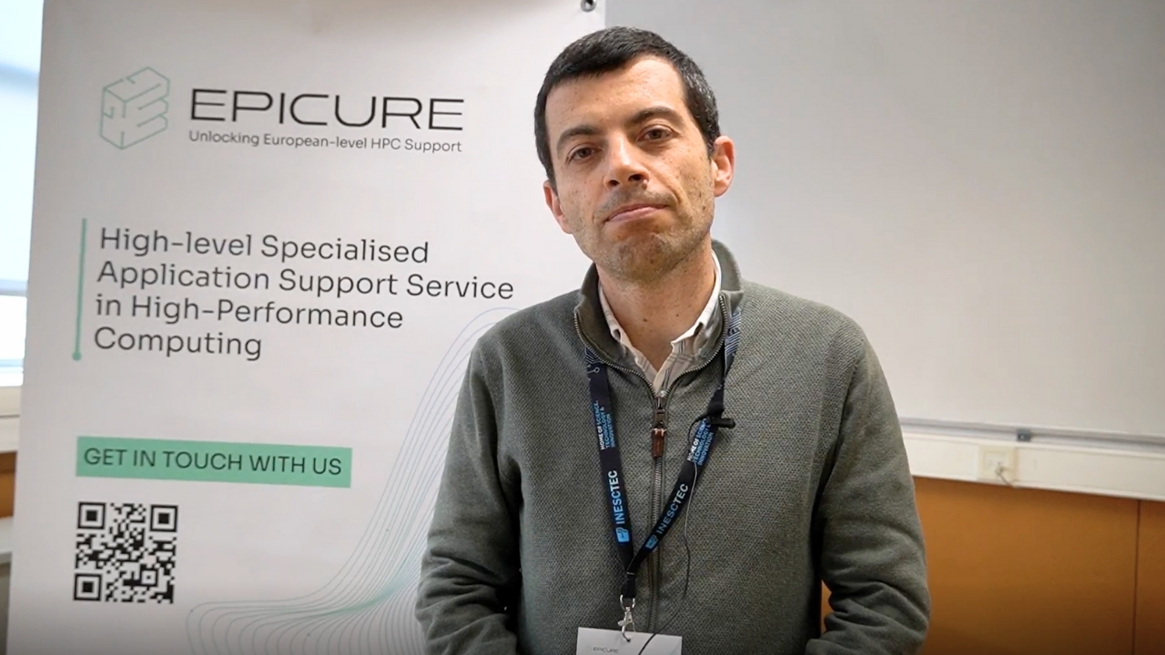 Man in a grey jacket in front of a roll up with the EPICURE logo.