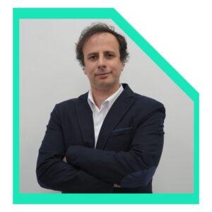 Men wearing a white shirt and a black blazer with arms crossed.