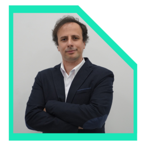 Men wearing a white shirt and a black blazer with arms crossed.