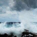 Powerful wave crashing against the shore.