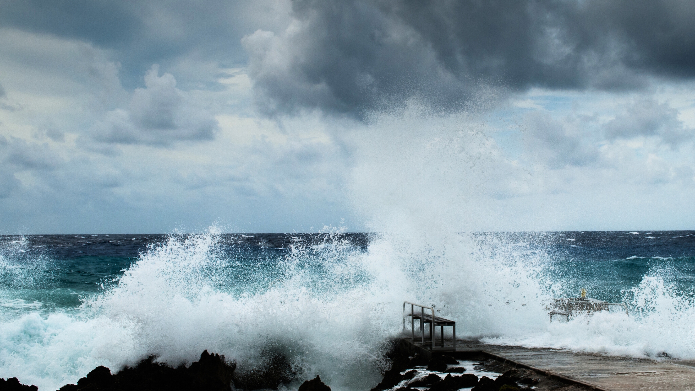 Powerful wave crashing against the shore.