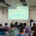 A man delivers a presentation on practical examples of high-performance computing support services to attendees at the Austrian-Slovenian HPC Meeting 2026.