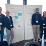 EPICURE team members and collaborators stand beside research posters during the Austrian-Slovenian HPC Meeting 2026.