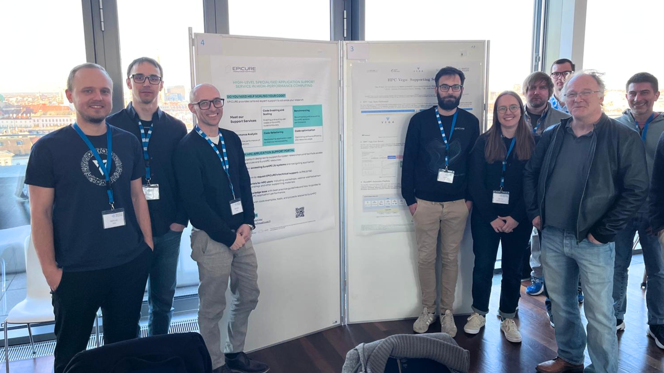 EPICURE team members and collaborators stand beside research posters during the Austrian-Slovenian HPC Meeting 2026.