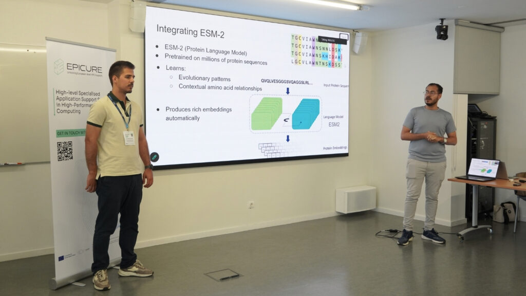 Two presenters delivering a talk on protein language models during an HPC workshop, standing beside a slide explaining ESM-2 and its applications.