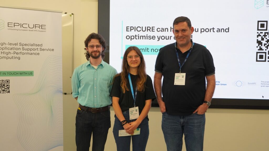 Two hackathon participants stand with an EPICURE representative during the award ceremony, posing in front of the presentation screen after receiving recognition at the EPICURE Hackathon.