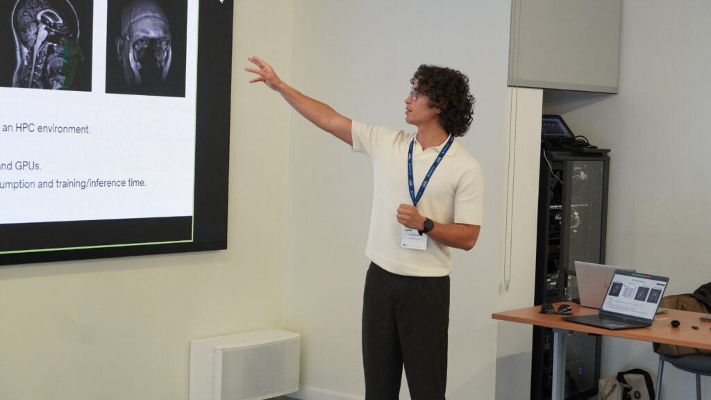Presenter pointing at a slide displaying medical imaging scans, explaining results during an HPC workshop session.