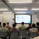 Audience attending a presentation on HPC in Portugal, with a speaker presenting slides at the front of a classroom-style workshop.
