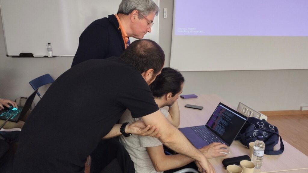 Workshop participants collaborate during a hands-on session with instructors providing direct support and guidance on HPC debugging and code optimisation tasks.