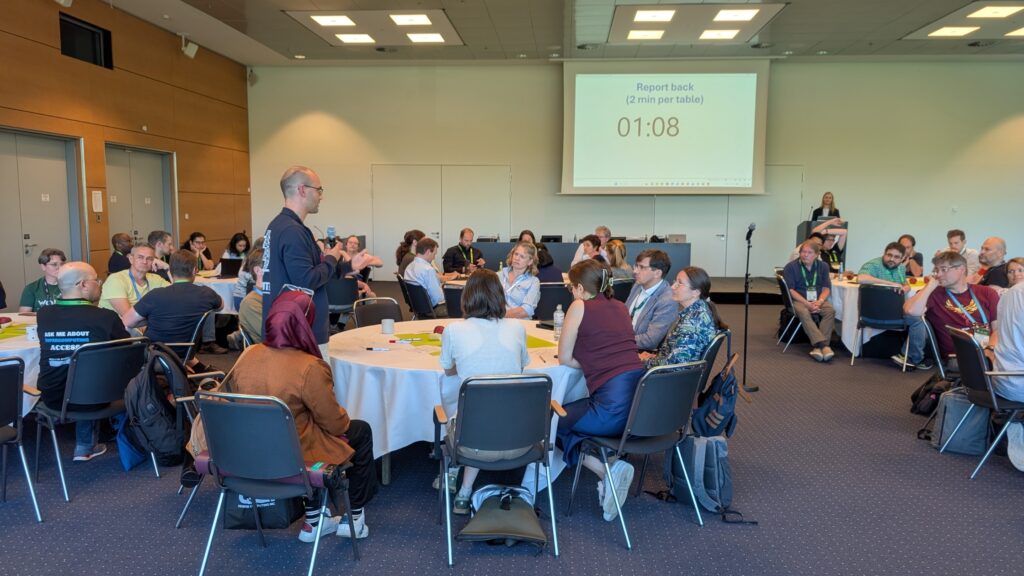 Participants engaged in roundtable discussions during an EPICURE workshop at ISC High Performance 2026.