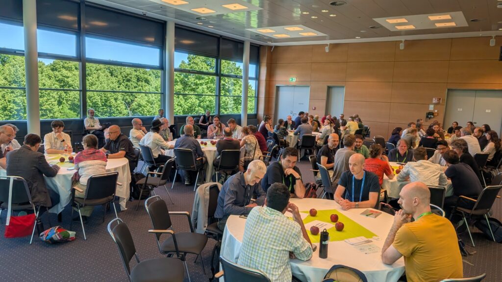 Participants gathered in roundtable discussions during an EPICURE workshop at ISC High Performance 2026, exchanging ideas on HPC user support.