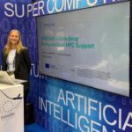 Woman presenting the EPICURE project at the EuroHPC Joint Undertaking booth during ISC High Performance 2026 in Hamburg.