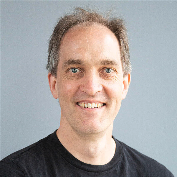 Men wearing a black t-shirt smiling